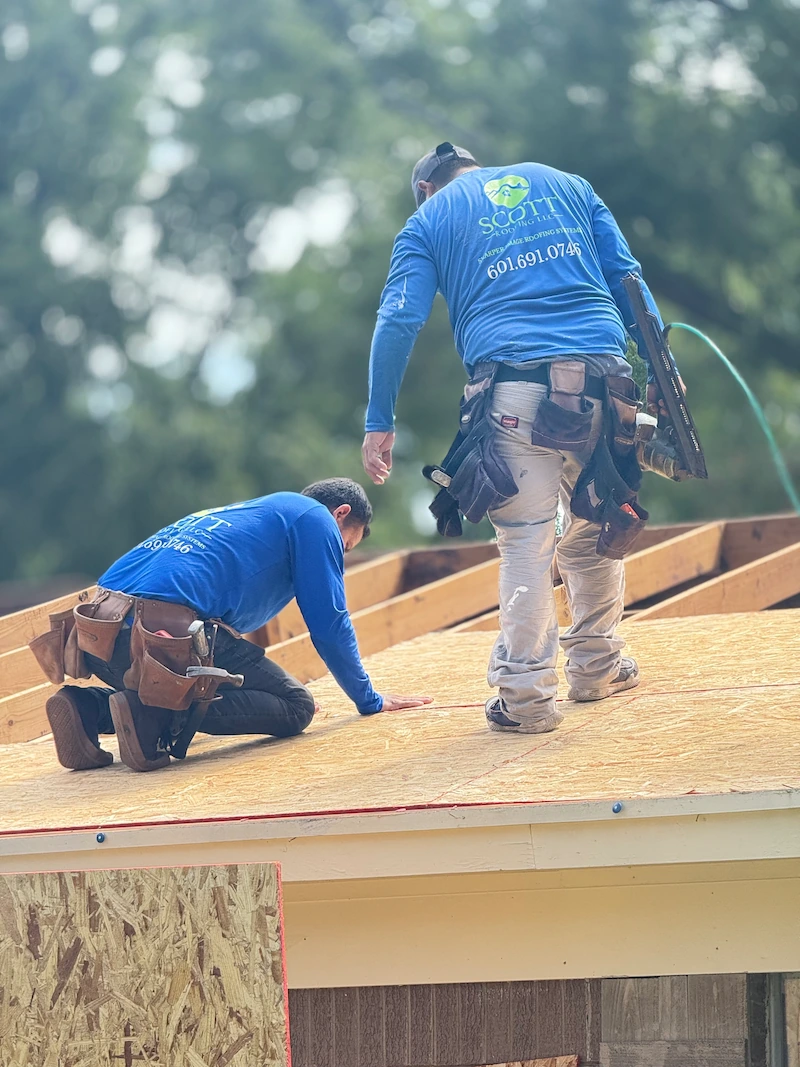 Scott Roofing team members working on a roof repair in Pearl, Mississippi